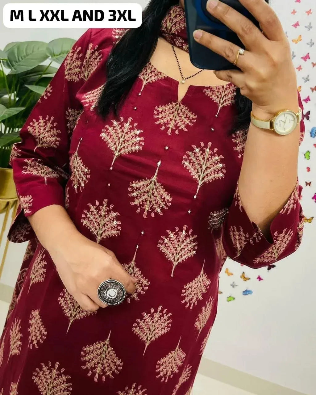 Close-up of woman wearing maroon festive kurti with mirror and handwork detailing