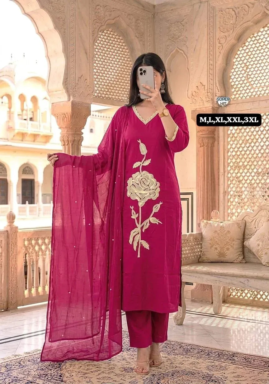 Woman wearing pink embroidered cotton kurti set with dupatta in traditional setting
