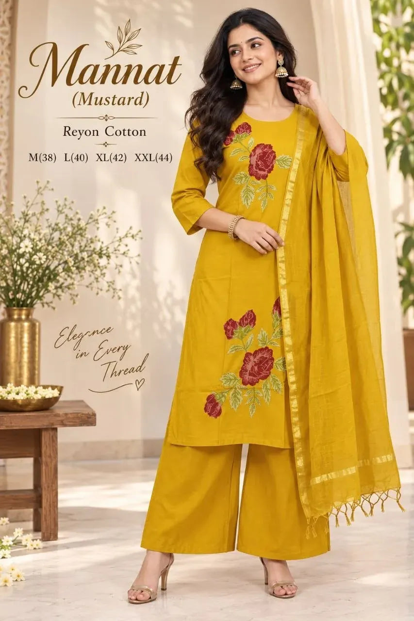 Model wearing mustard rayon cotton suit with floral embroidery and dupatta