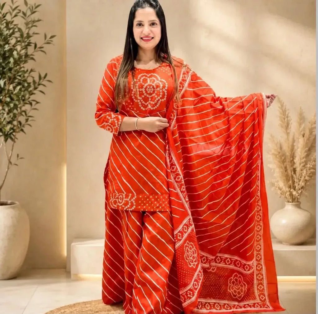 Model posing gracefully in vibrant orange cotton kurti palazzo set