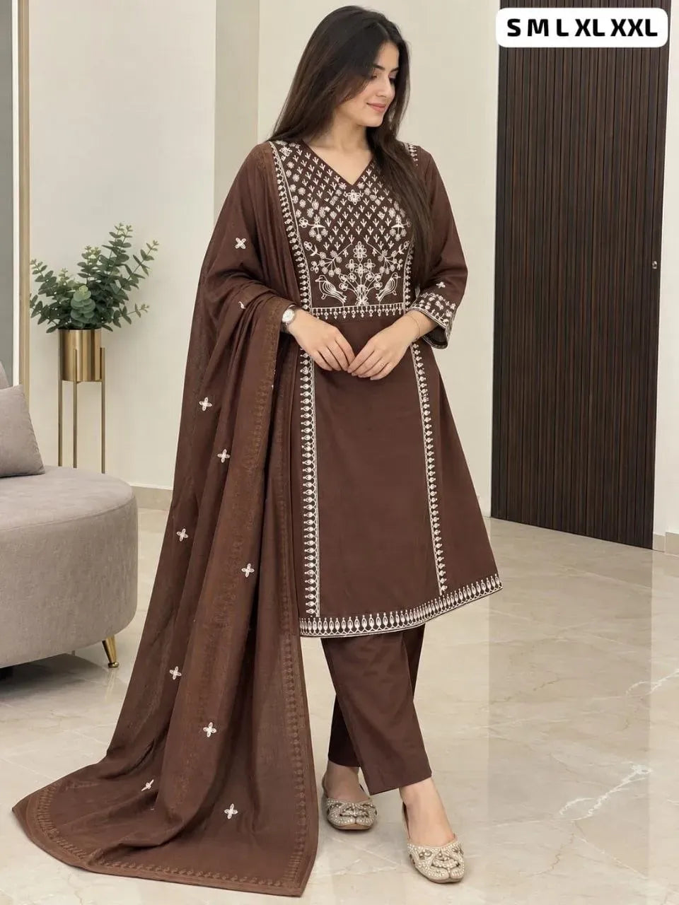 Model wearing brown embroidered cotton kurti with matching pants and dupatta