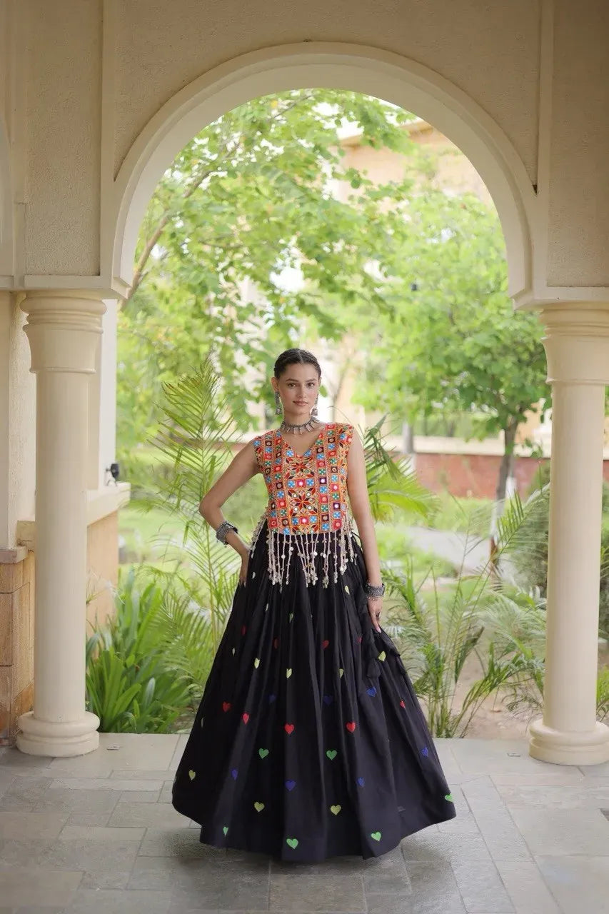 Model wearing black cotton lehenga with colorful heart embroidery and embroidered blouse