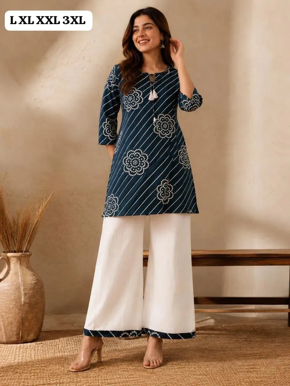Model wearing dark blue dhabu print kurti with white khadi palazzo pants