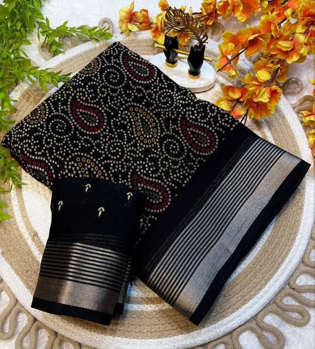 Folded black georgette saree with silver border and matching blouse