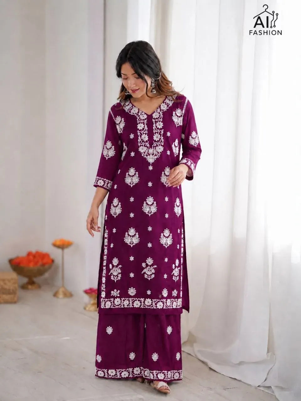 Model wearing purple heavy chikankari kurti with matching palazzo
