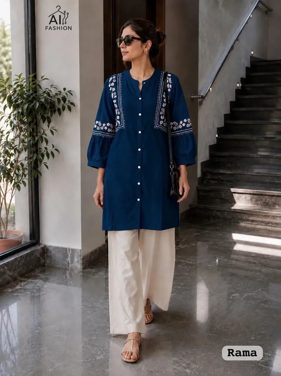 Model wearing dark blue embroidered short top with white palazzo pants