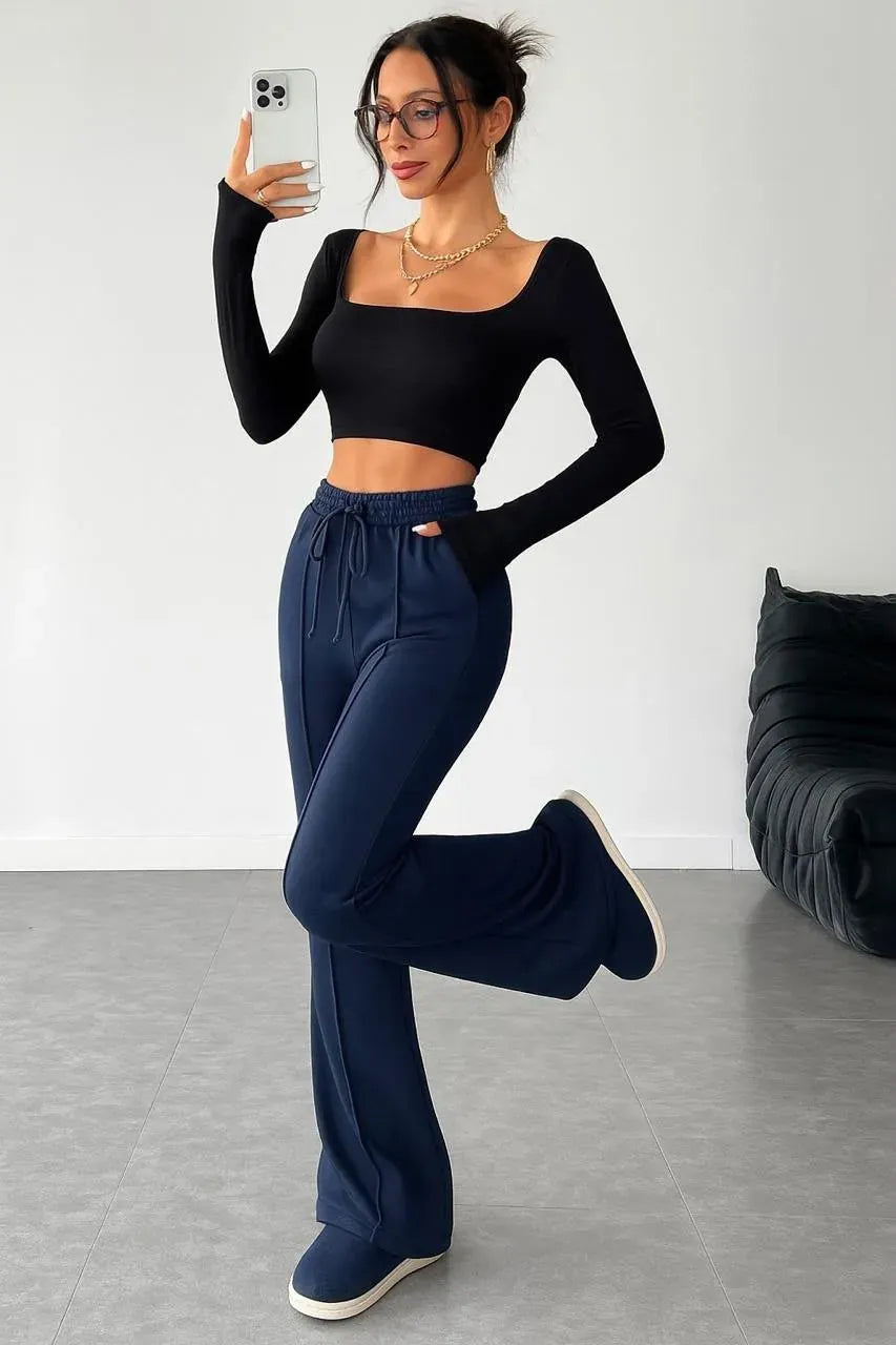 Full body front view of woman wearing navy blue Korean pants