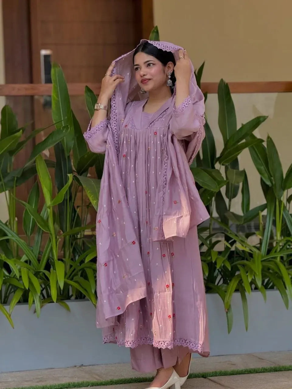 Model wearing lavender chanderi anarkali set holding dupatta