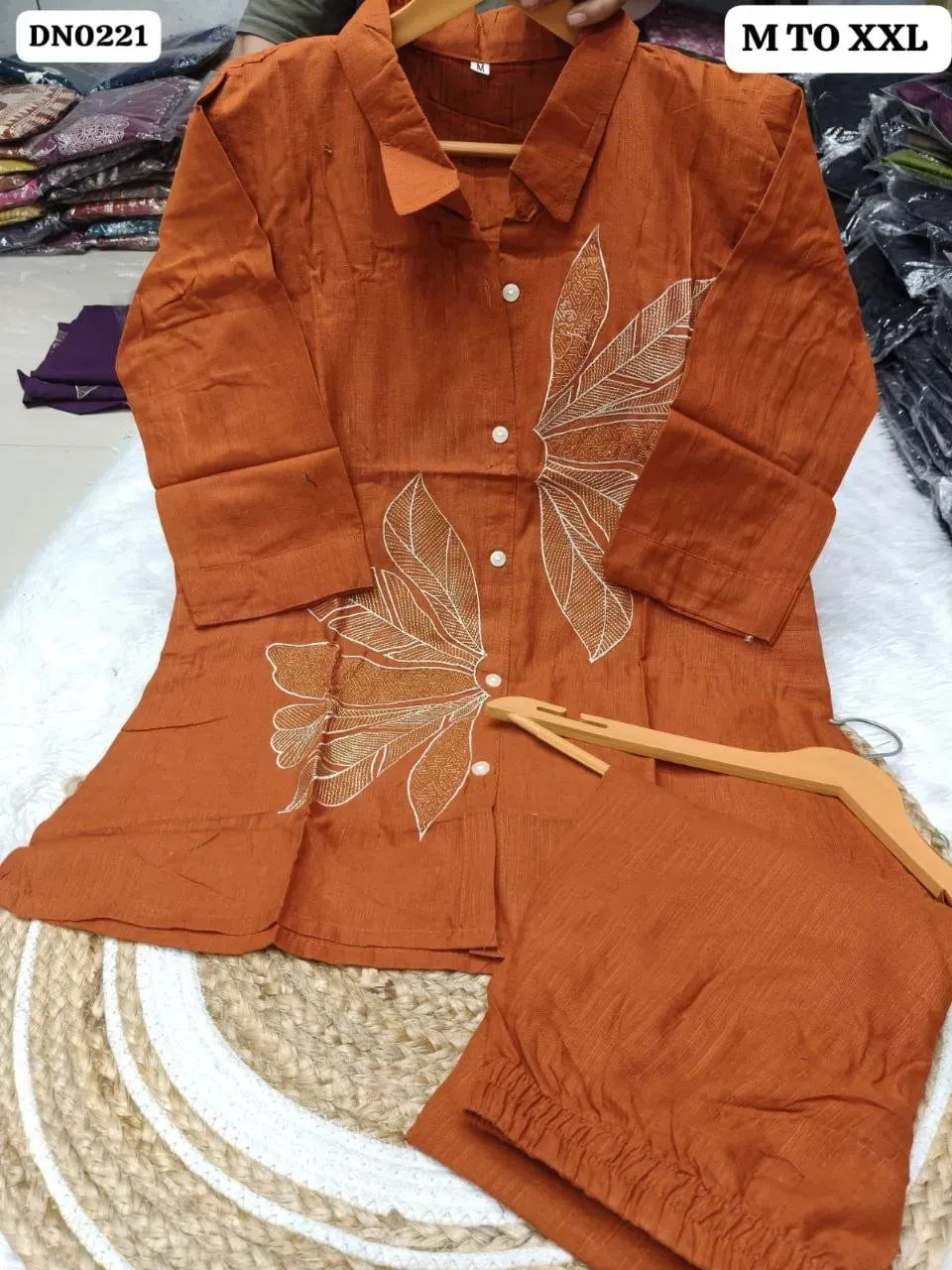 Rust orange pure cotton cord set with leaf embroidery on wooden hanger