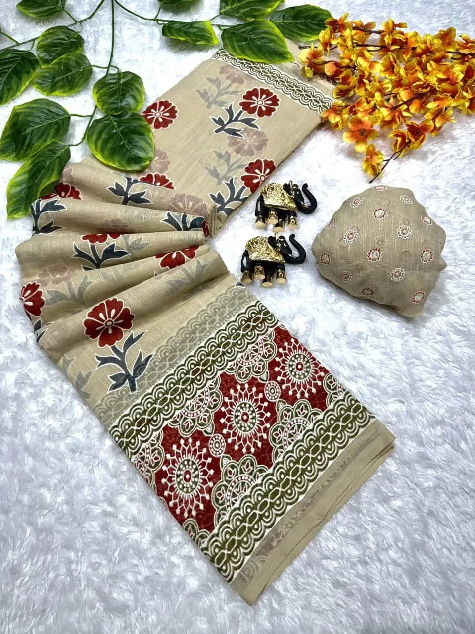 Folded beige pure linen cotton saree with red floral print and elephant decor