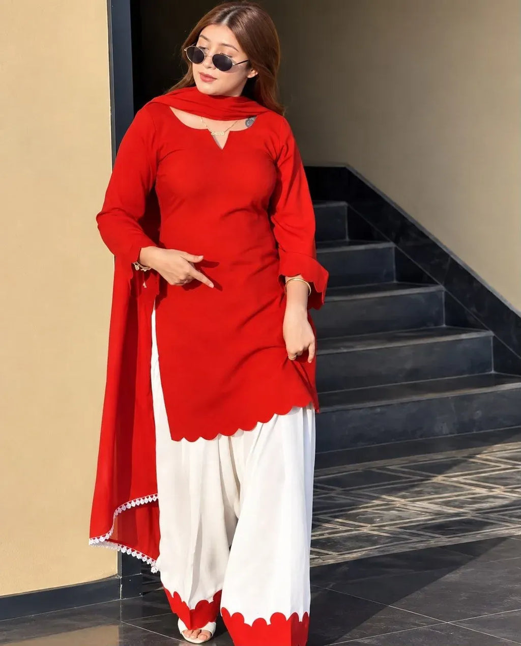 Model wearing red chanderi kurti and white palazzo with sunglasses