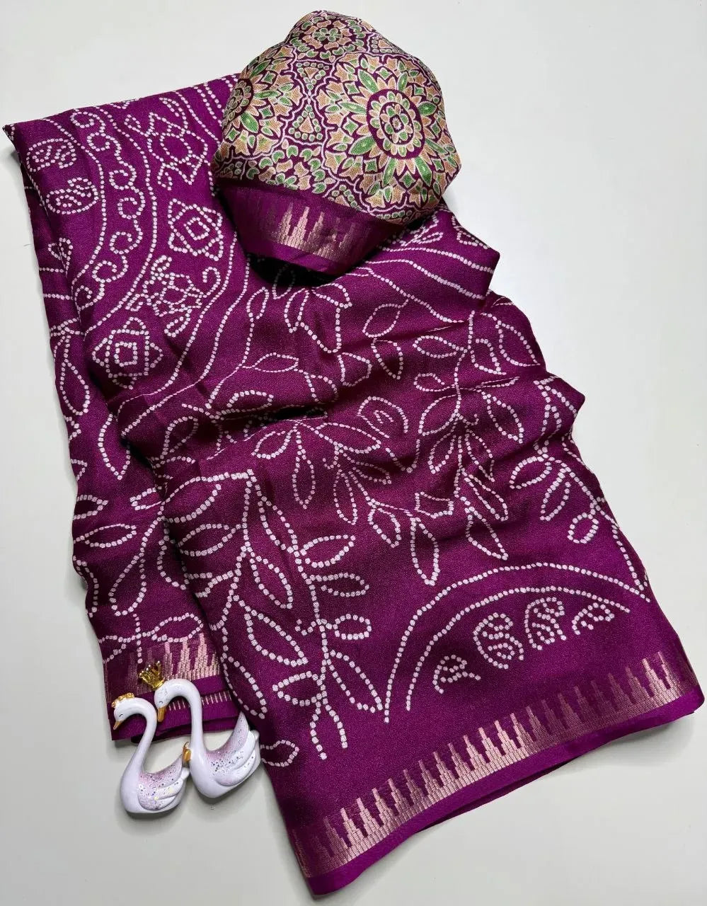 Purple pure soft 3D print saree folded with matching blouse piece
