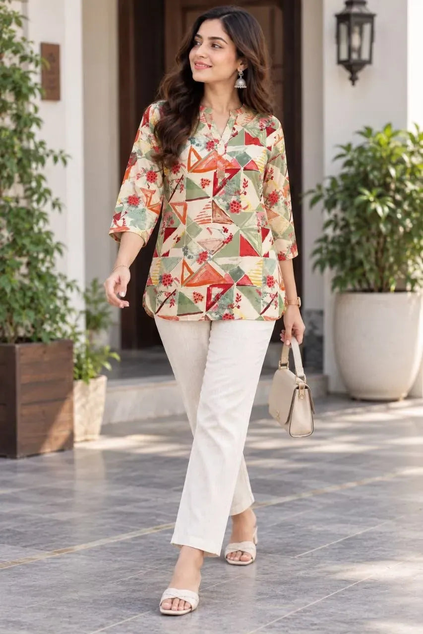 Model walking in geometric multi-color digital print rayon top and white khadi cotton pants