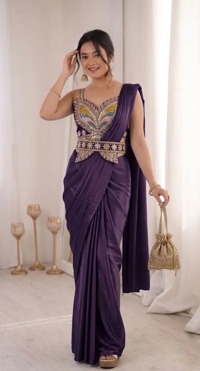 Model standing and posing in a purple ready to wear saree with embroidery