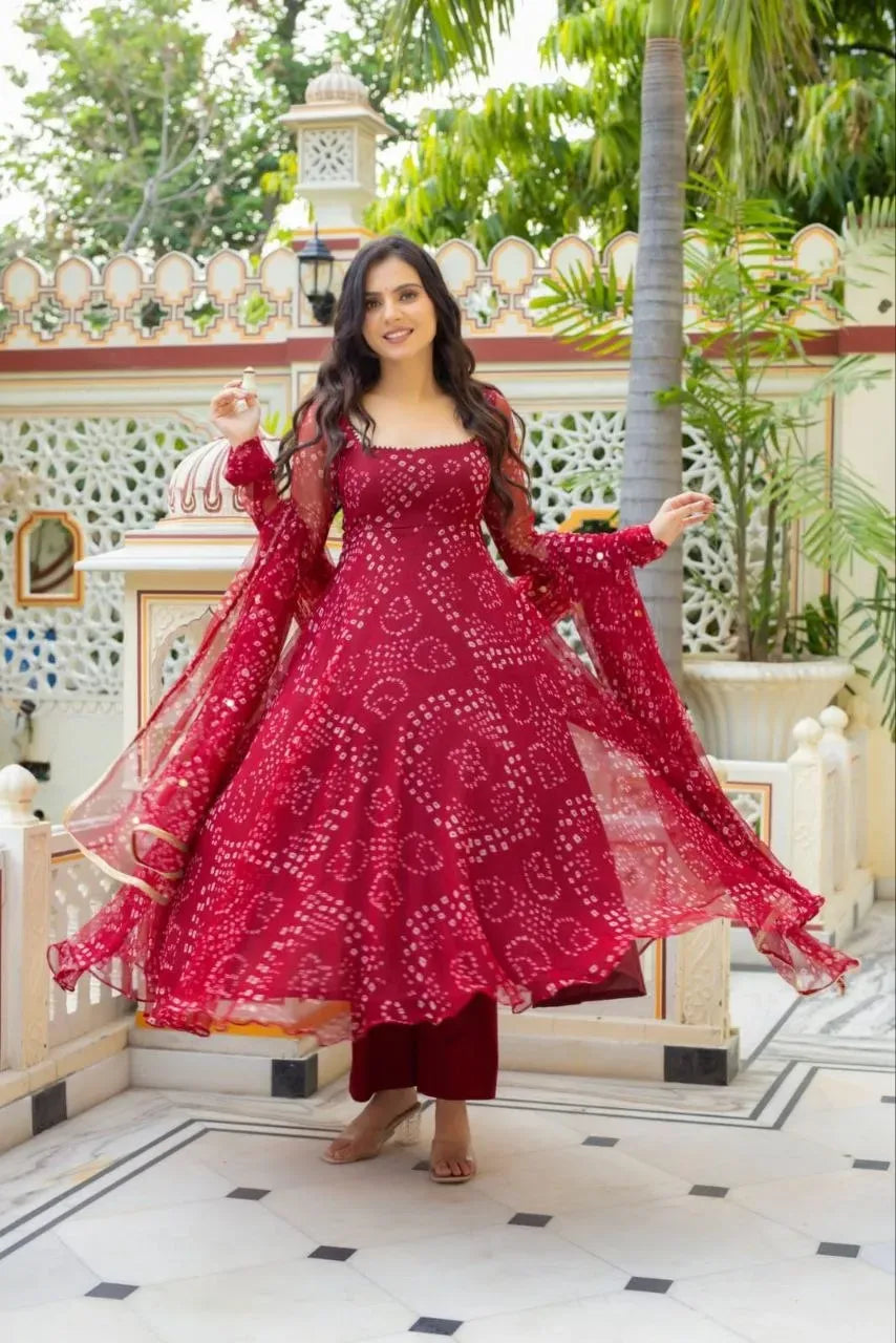 Model wearing red bandhani print anarkali suit with palazzo and dupatta outdoors