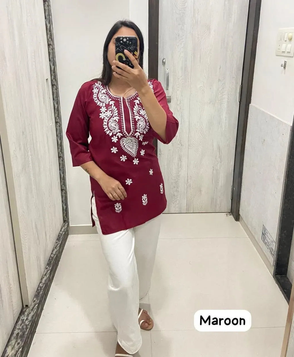 Maroon short rayon chikankari kurti with white embroidery on model