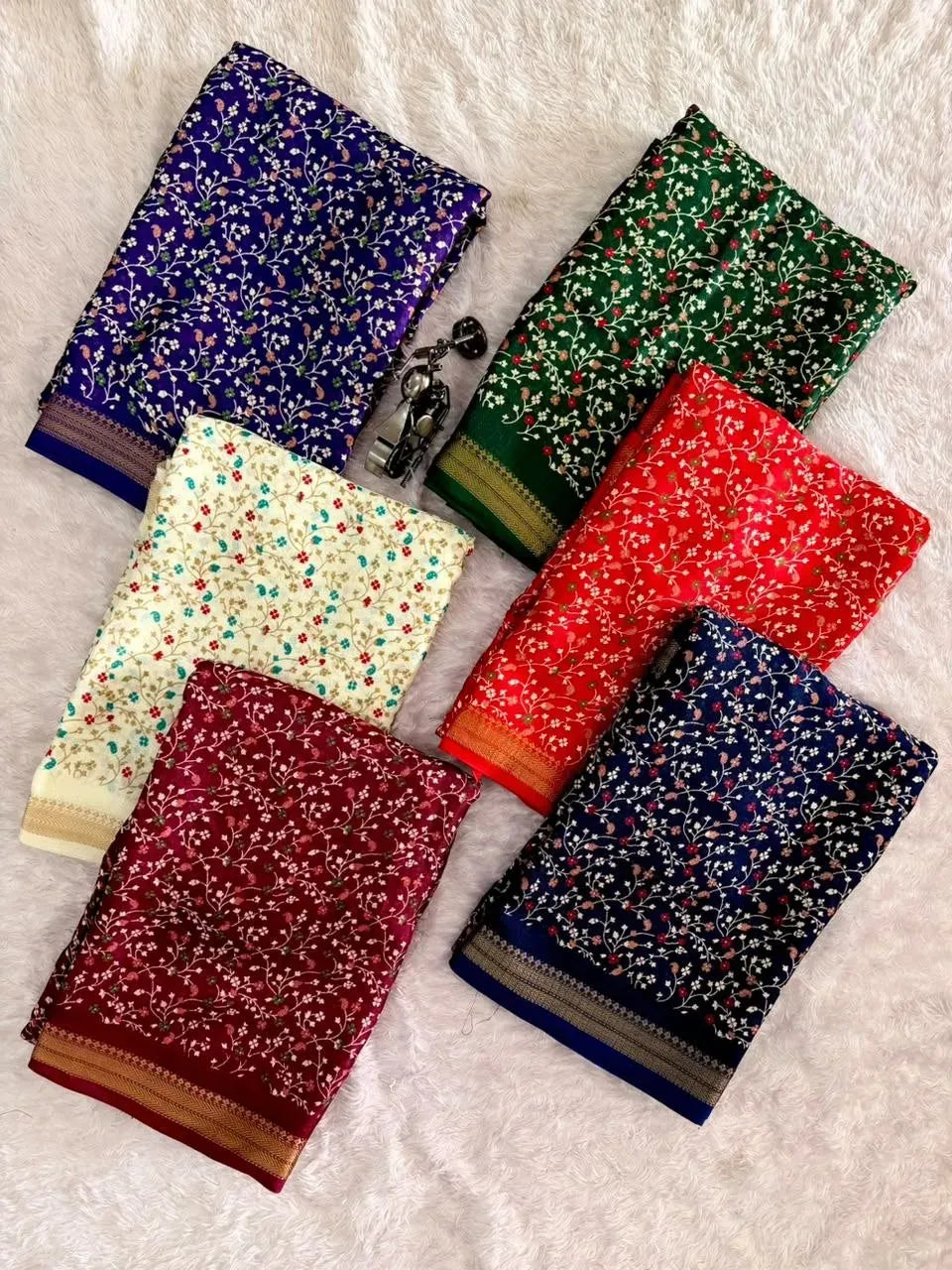 Flat lay showing assortment of star georgette sarees in multiple colors