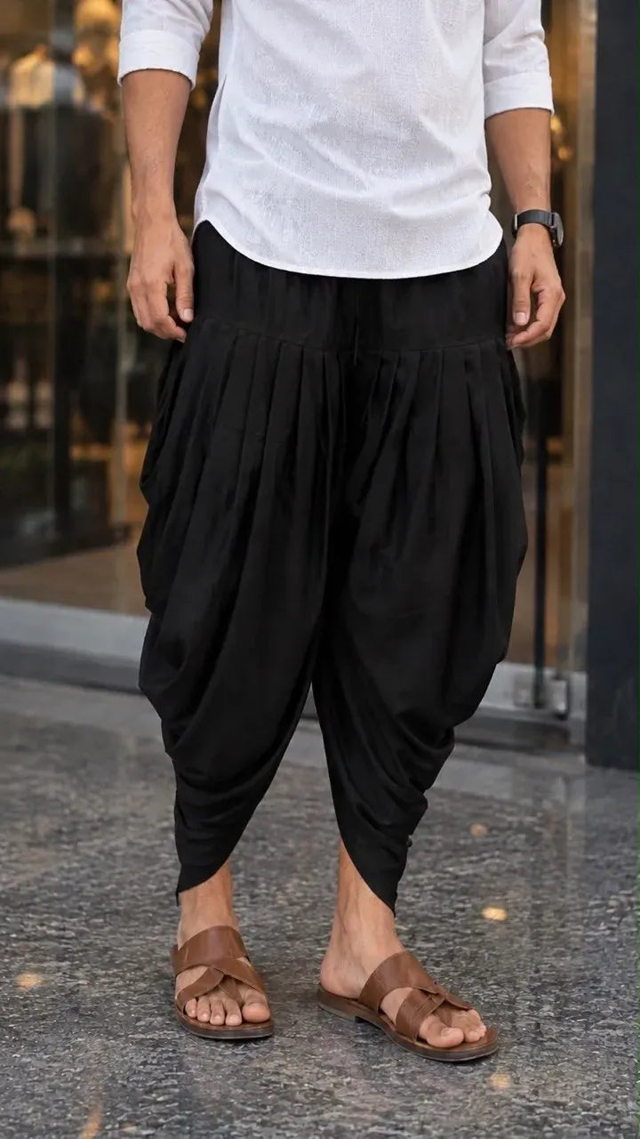 Model wearing a black soft poly cotton dhoti with brown sandals