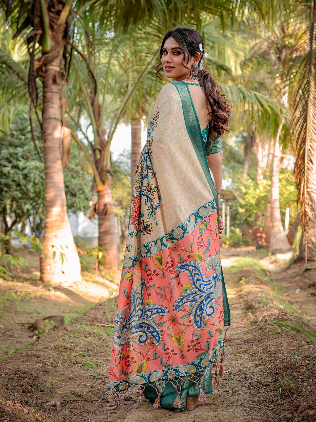 Close-up of the intricate green woven zari border and delicate tassel finish on the edge