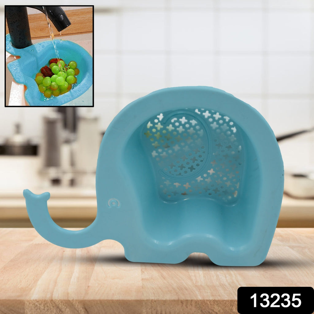 Grey elephant shape drain strainer in a kitchen sink, catching food debris.