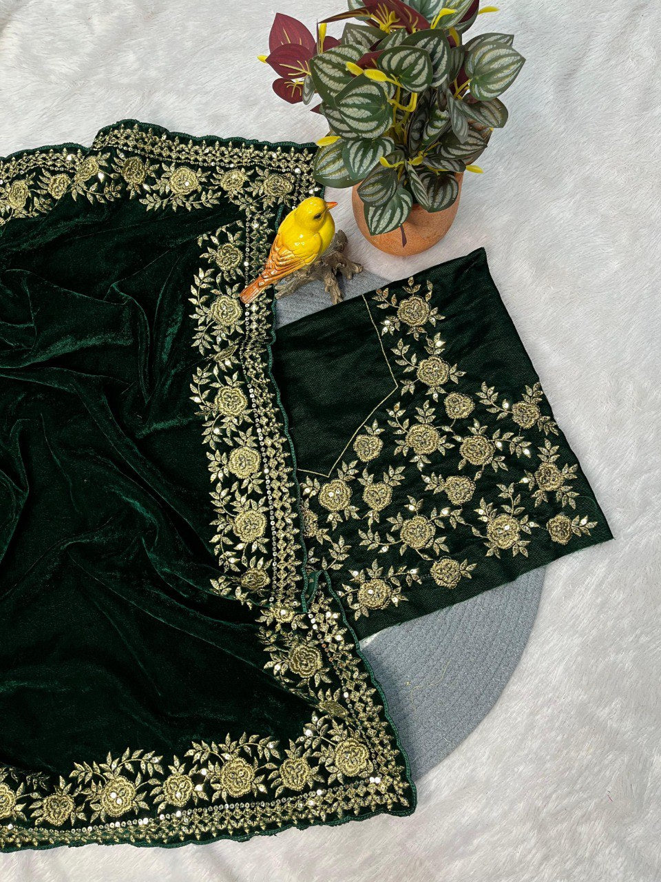Dark green velvet saree with gold sequin and jari dori embroidery, showcasing the blouse piece.