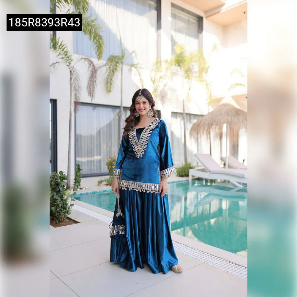 Full shot of model wearing Teal Blue Velvet Mirror Work Suit Set with plazo, front view by pool
