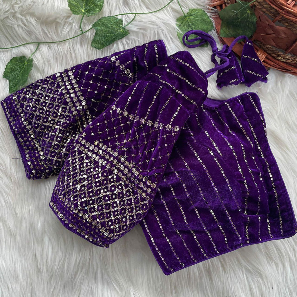 Close-up shot of a purple velvet blouse with all-over golden sequin and thread embroidery on the sleeves and vertical stripes on the body.