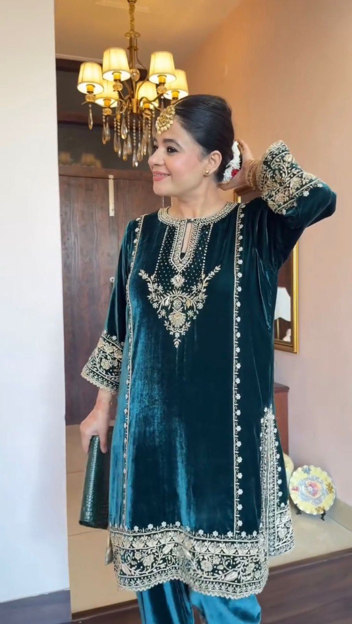 Woman in a deep teal velvet sequence embroidered kurta palazzo set, smiling