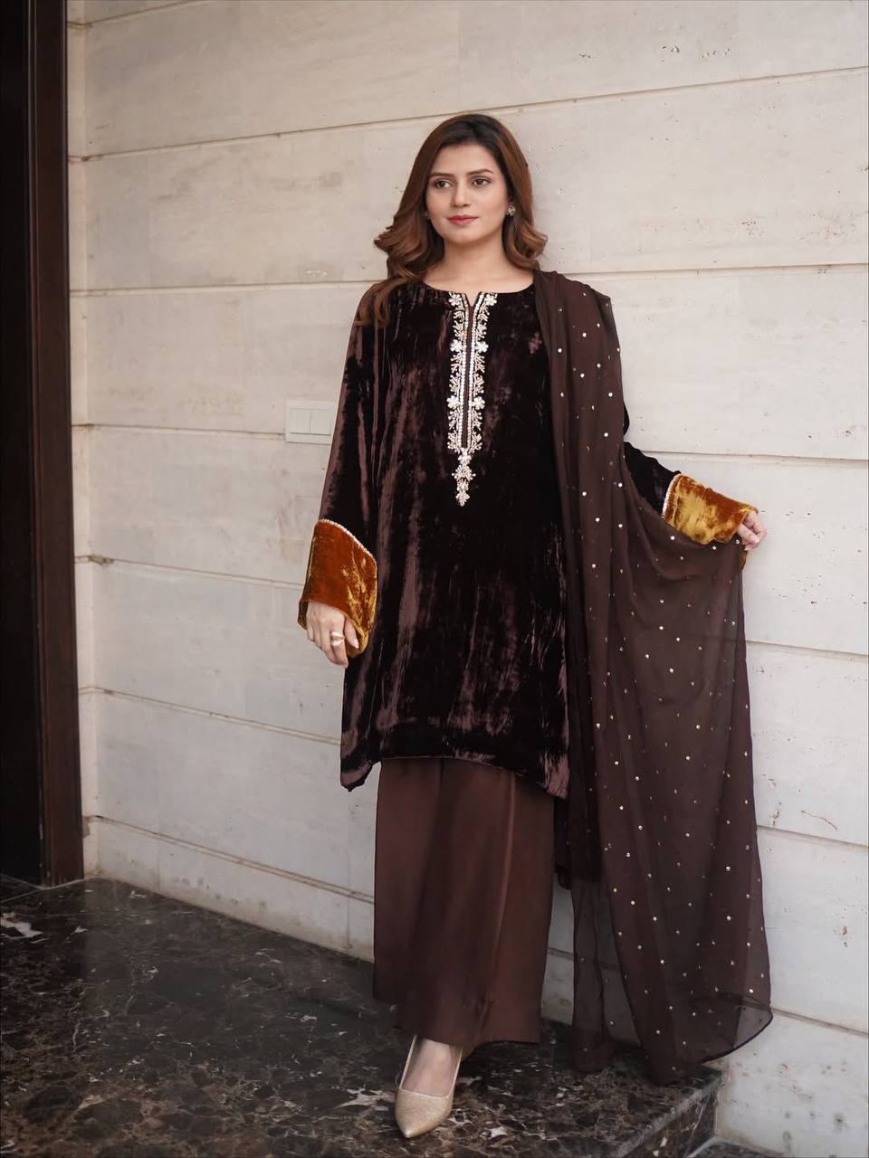 Full body shot of a model wearing a rich brown velvet plazzo suit with sequence embroidery.