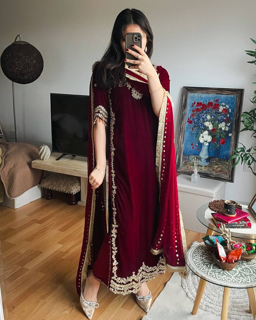 Full body shot of model in maroon velvet suit with golden embroidery and draped georgette dupatta