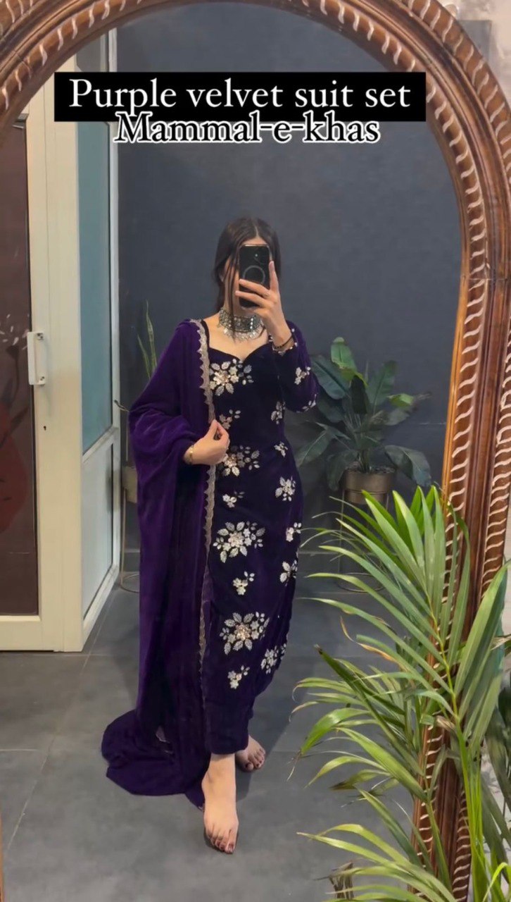Woman in purple velvet suit set with intricate embroidery and matching dupatta