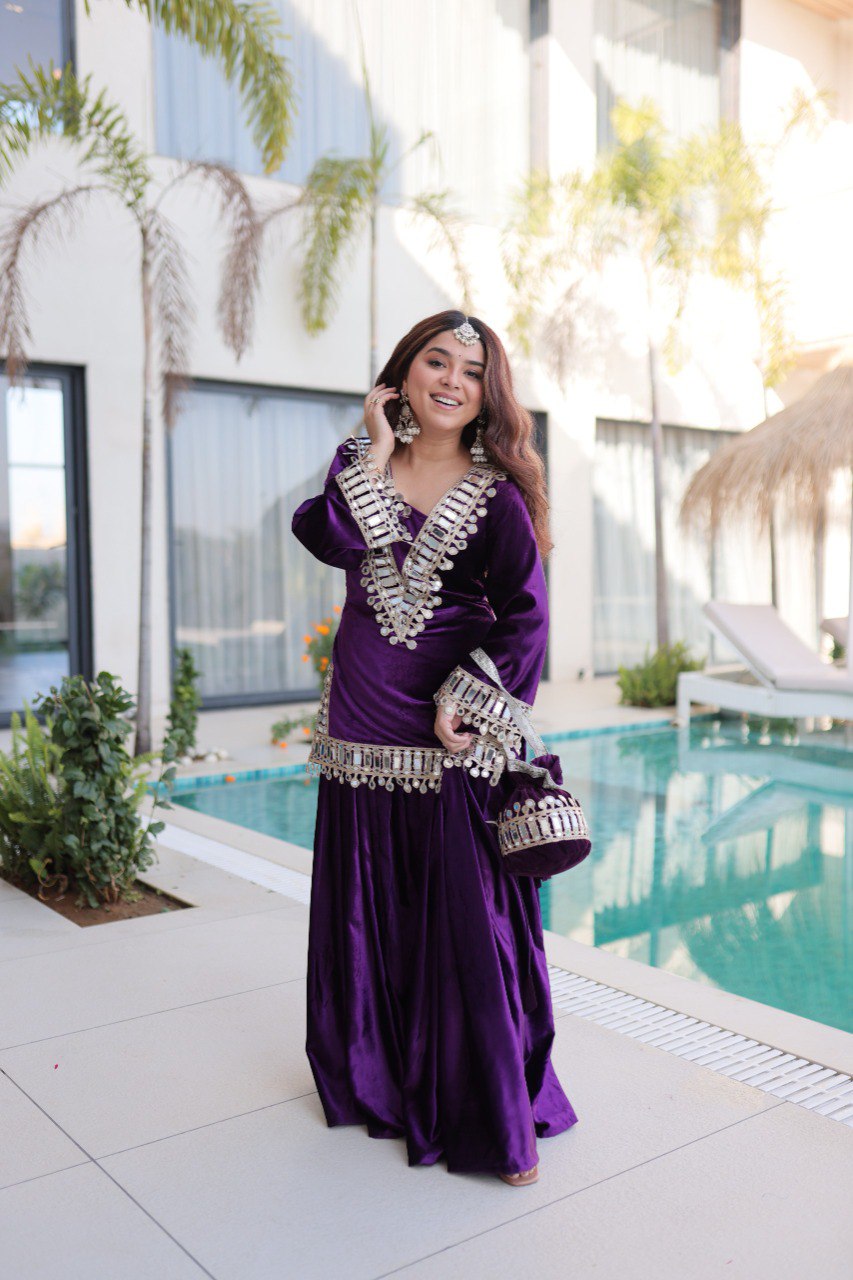 Model in Royal Purple Velvet Sharara Set with Zari and Mirror Work by a pool.