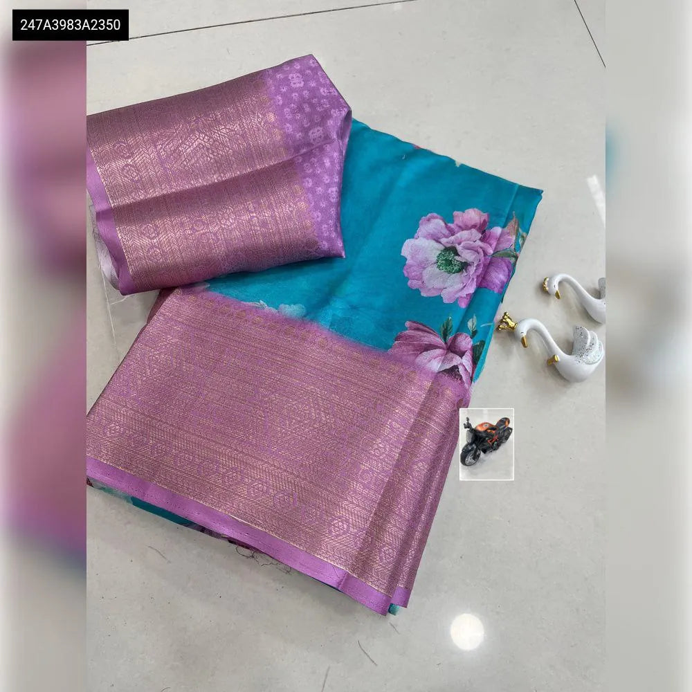 Vibrant Dola Silk Saree with digital floral print and lavender jacquard border, complete with matching blouse piece, flat lay.