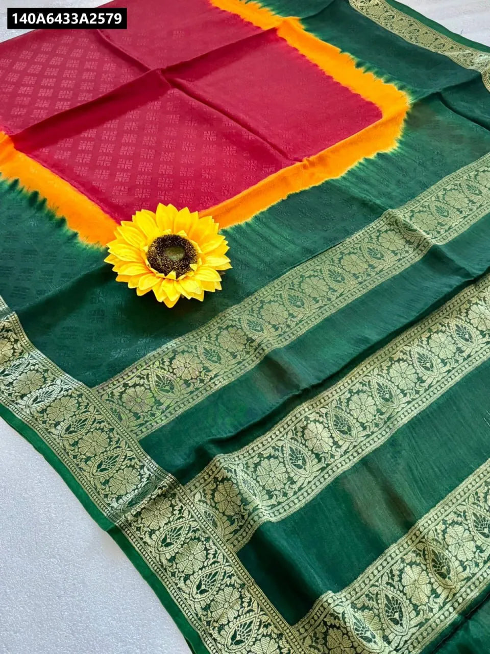 Trendbuy Emerald Sunset Hand-Dyed Cotton Silk Saree, flat lay showcasing green, yellow, and red tie-dye with gold border