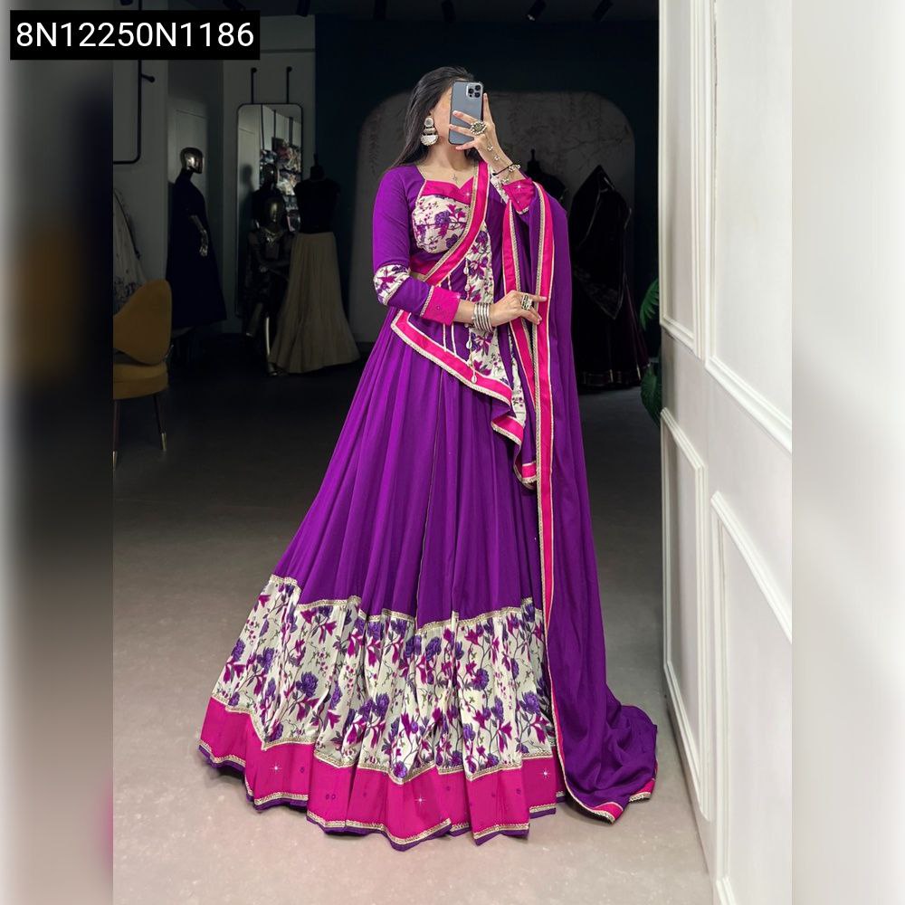 Front view of model wearing Vibrant Purple Printed Mirror Work Lehenga Set with dupatta