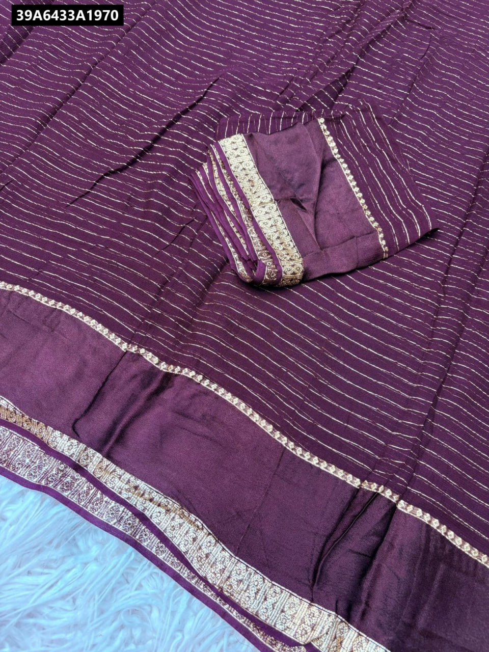 TRENDBUY Pure Viscose Georgette Saree with intricate weaving and satin patta border in Dark Plum, flat lay.