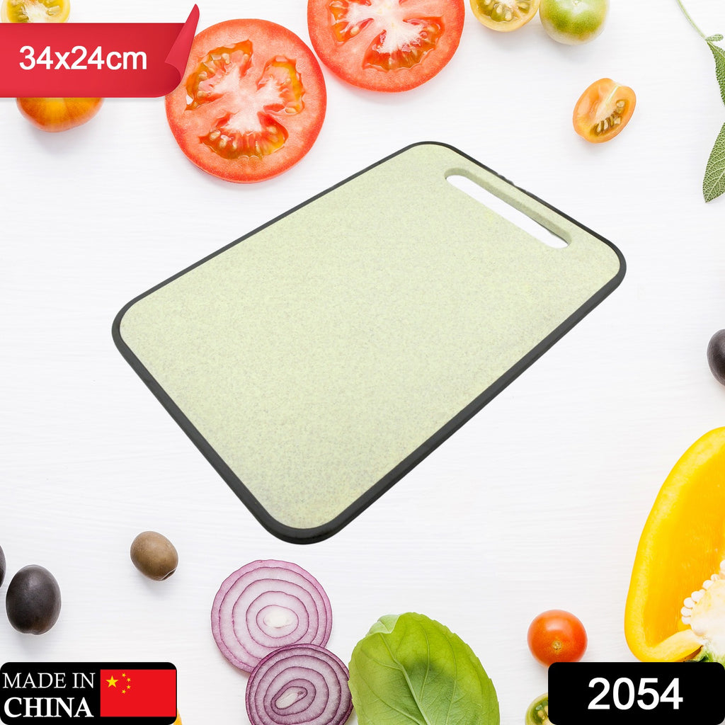 Multi-purpose white plastic cutting board (34x24cm) for household vegetable and fruit prep.