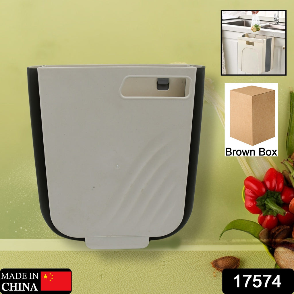 Small collapsible hanging waste bin on a kitchen cabinet door.