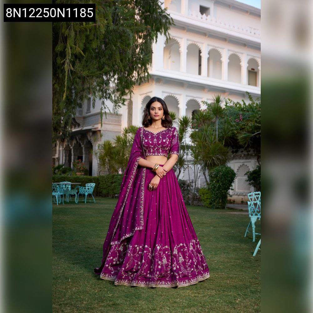 Front view of woman in elegant wine purple Vichitra Silk lehenga choli with sequin and thread embroidery, outdoor