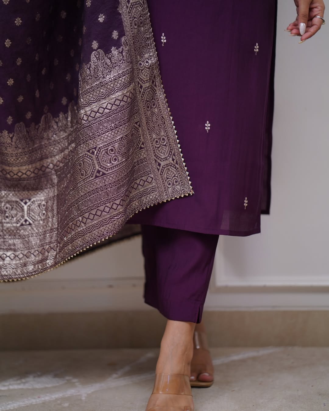 Close-up shot of the lower part of the TRENDBUY ST-SWATI wine kurti set, showing the kurti, pant, and the lower border of the cotton jacquard dupatta with model's feet.