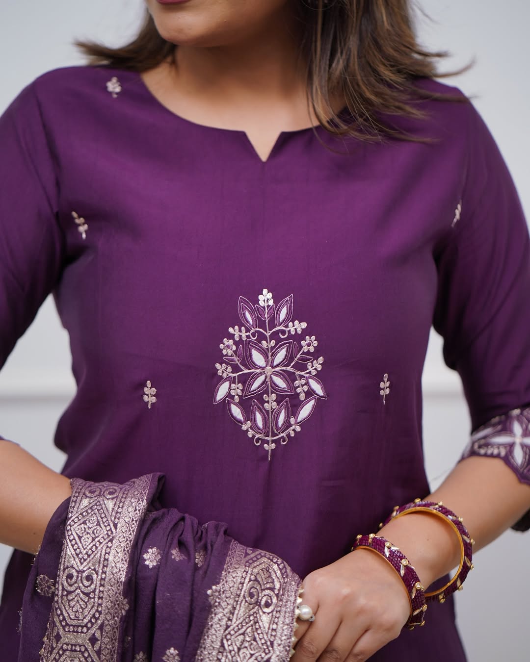 Close-up of model's torso in TRENDBUY ST-SWATI wine PV Chanderi kurti, highlighting the chest embroidery and accessories like bangles.