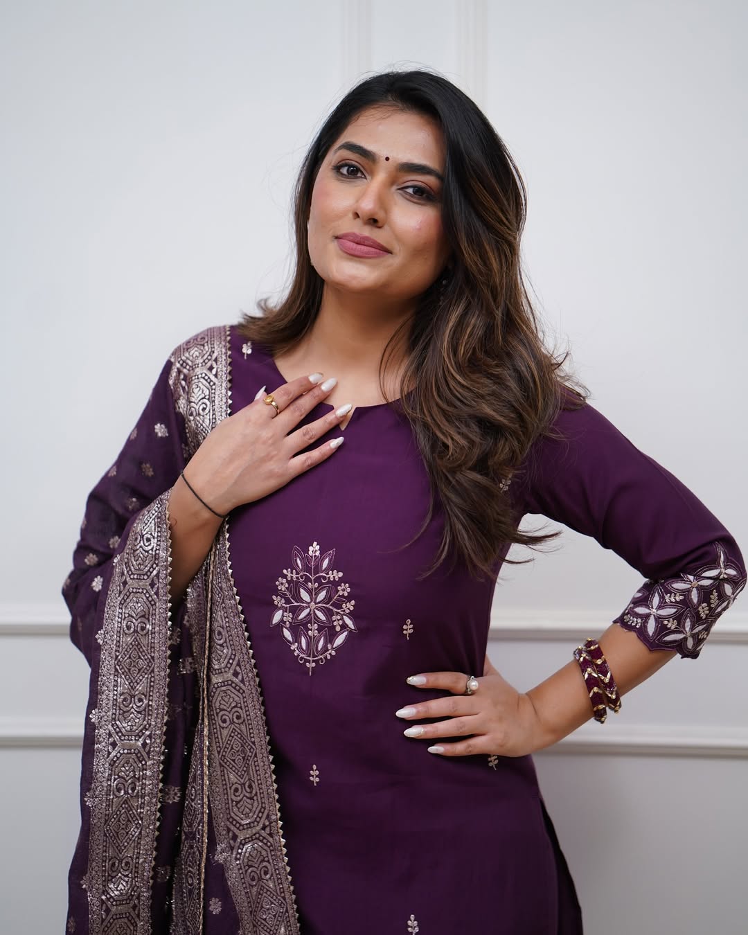 Model posing confidently in TRENDBUY ST-SWATI wine kurti set, hand on hip, showcasing the outfit's flattering silhouette and rich color.