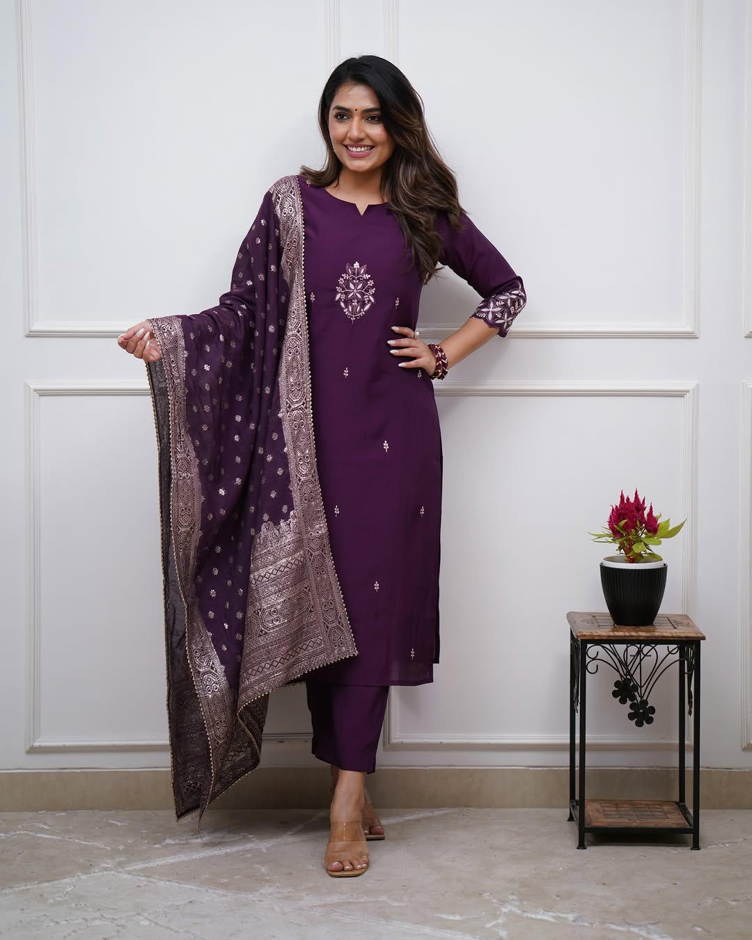 Model in TRENDBUY ST-SWATI wine kurti set, looking away with a gentle smile, highlighting the elegant drape of the dupatta and overall style.