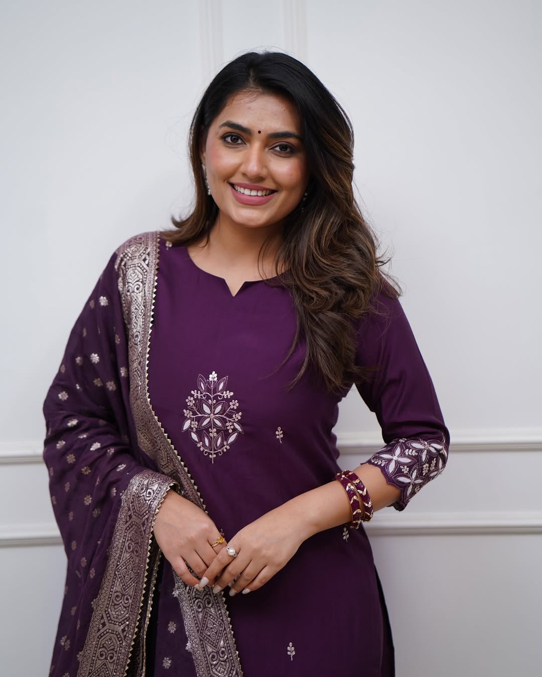 Full body shot of model wearing TRENDBUY ST-SWATI wine kurti set, gracefully adjusting the cotton jacquard dupatta, emphasizing movement and elegance.