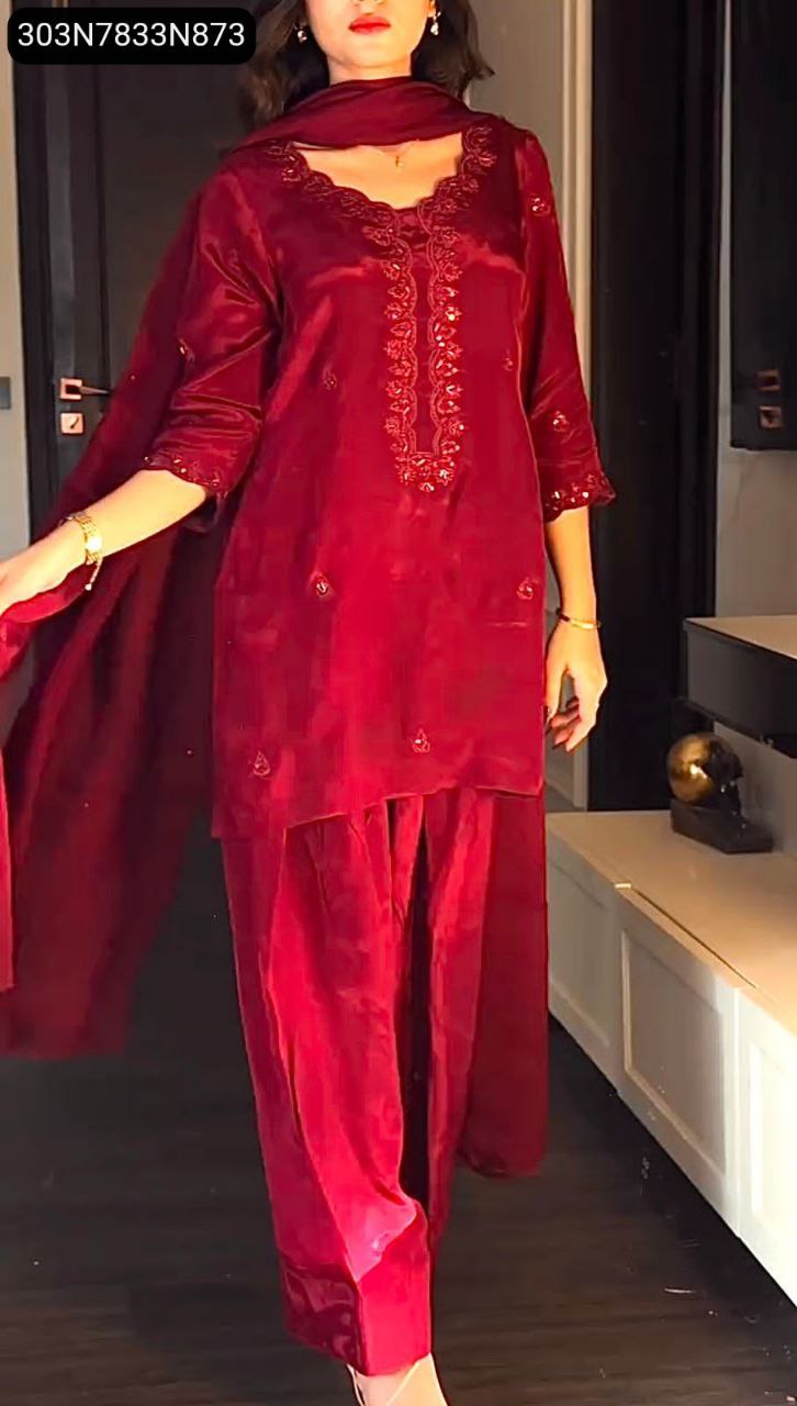 Full shot of a woman wearing a crimson red 3-piece chinon silk kurti set with farsi salwar and dupatta, posing indoors, highlighting the outfit's elegance.