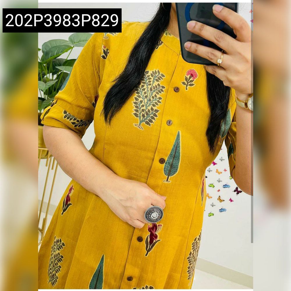 Close-up of a woman in a yellow A-Line kurti co-ord set with digital tree and leaf print.