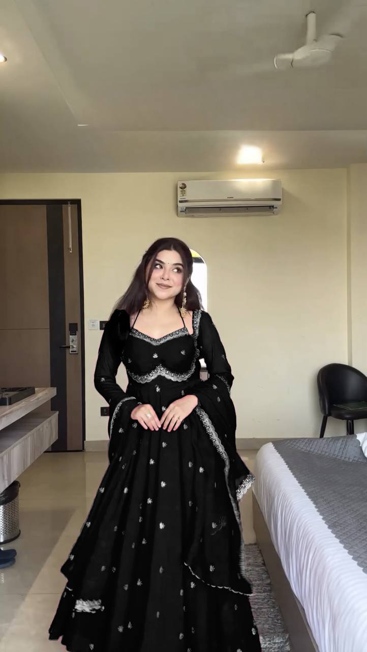 Woman modeling Charcoal Black Faux Georgette Anarkali Gown Suit, full body front view.