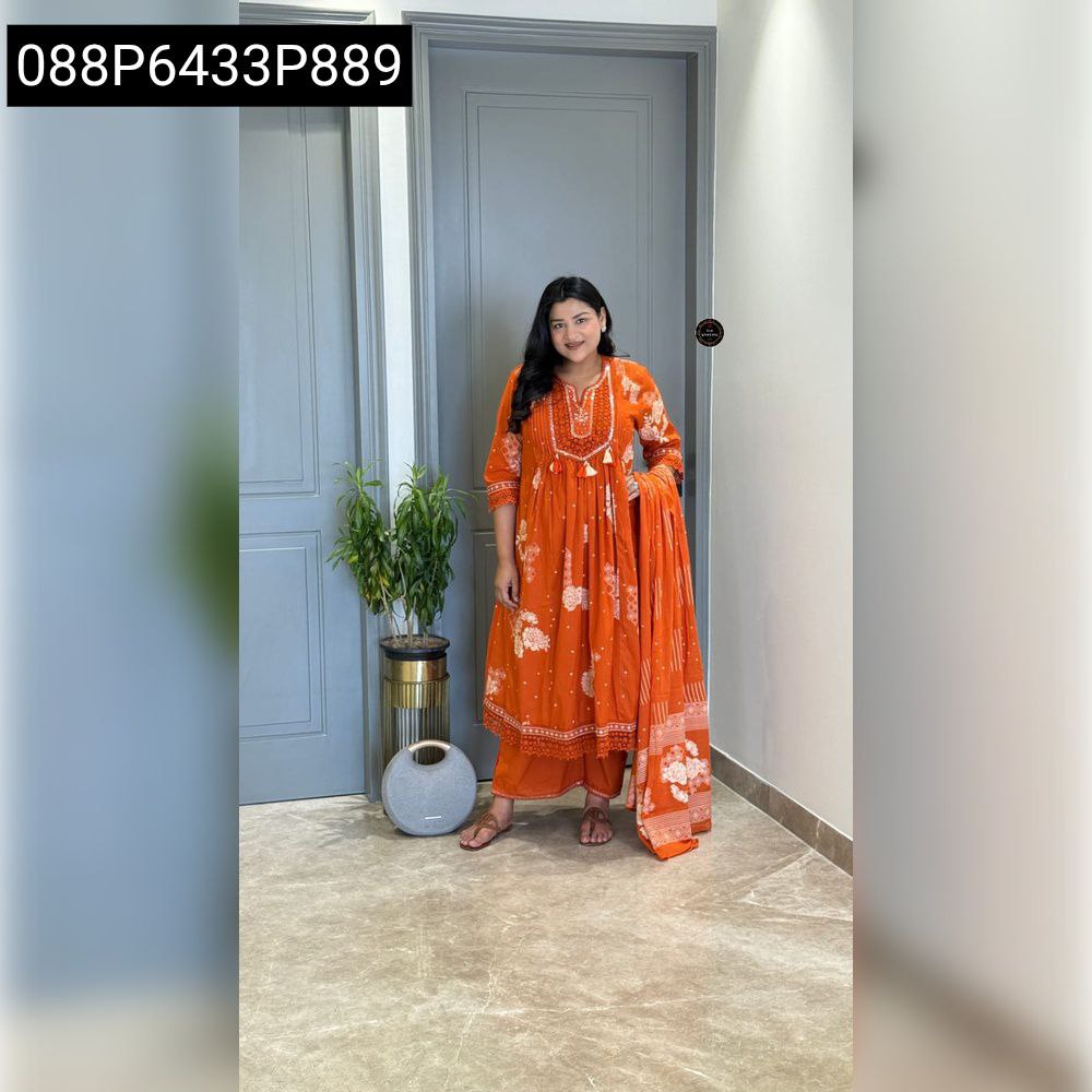 Full-body front shot of a woman confidently posing in a vibrant orange Anarkali kurti set, showcasing the tier pattern and handwork.