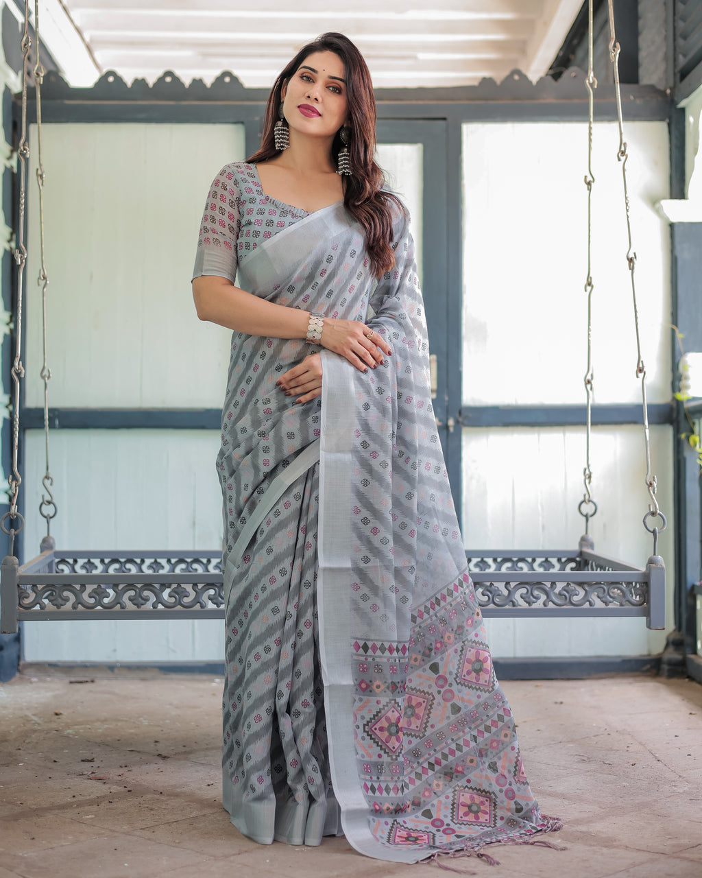 Full body shot of a woman in a grey ikat print linen saree, front view