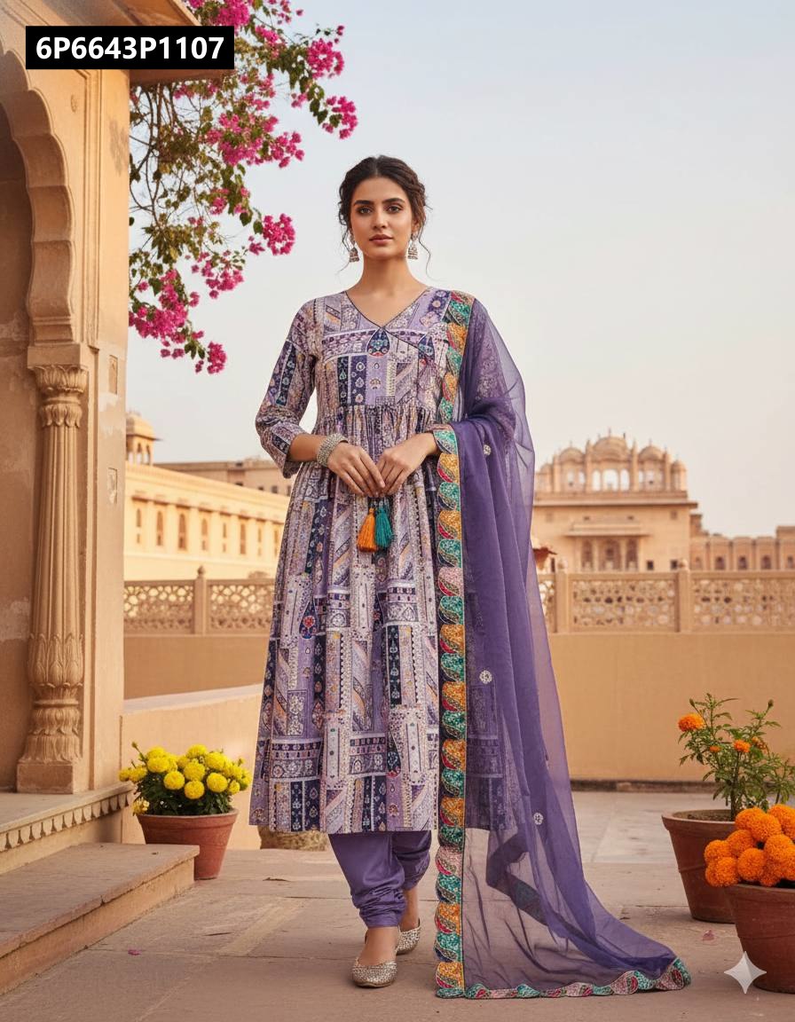 Model in a stylish lavender multi-print Chinnon silk Anarkali suit with a coordinating dupatta, posing in an ornate outdoor setting.